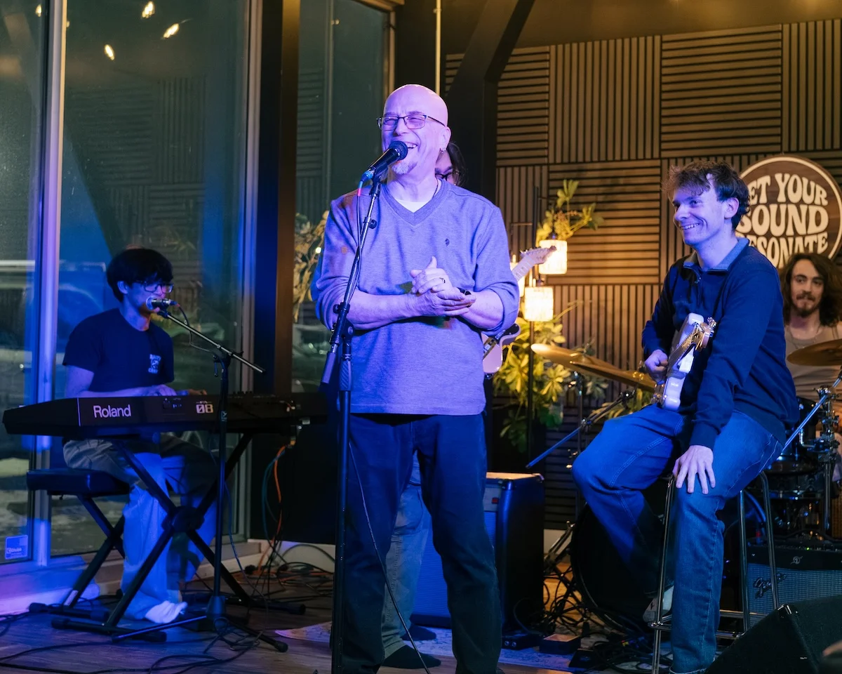 Mike Chenoweth at the mic with house players on keys, guitar, and drums at the Resonate After Hours Open Jam
